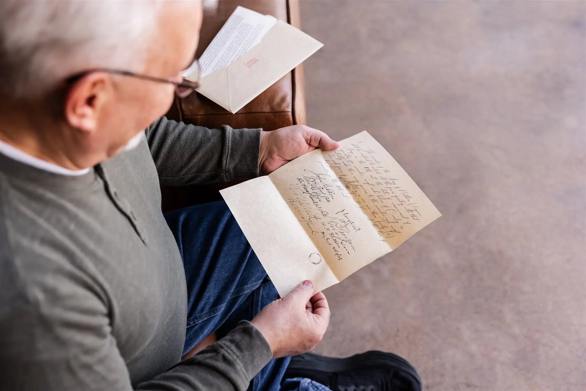 Man holding a History By Mail replica document