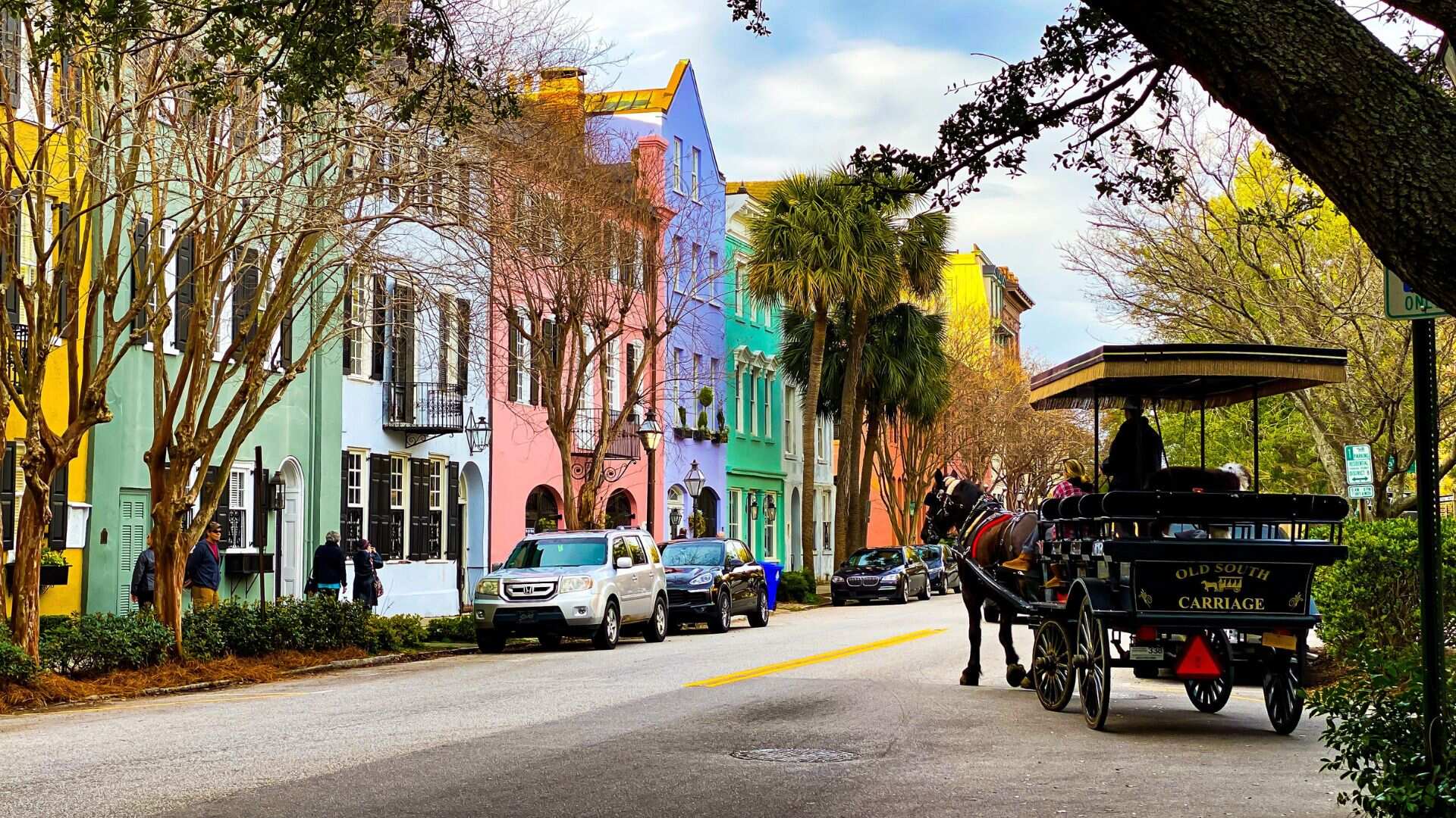 Colorful buildings and a horse carriage in Charleston, South Carolina. - History By Mail