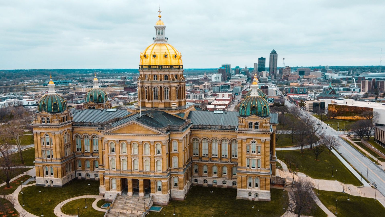 Aerial view of Des Moines Capitol building with the city in the background. - History By Mail