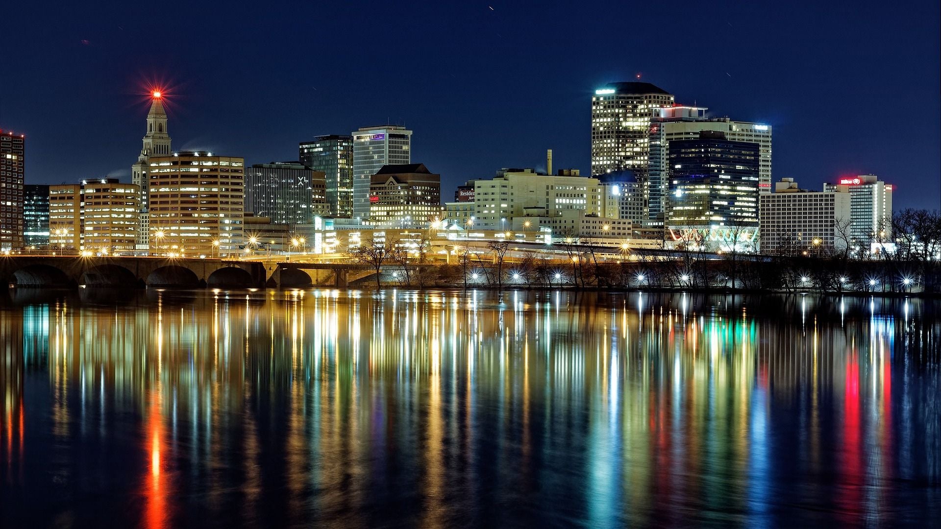 Hartford skyline at night with water reflection. - History By Mail