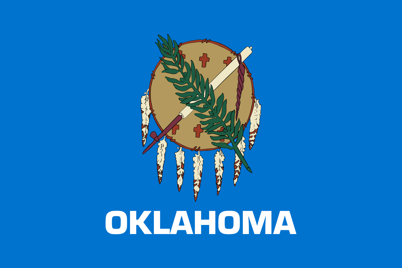 The official state flag of Oklahoma was adopted in 1925 and showcases a Buffalo-skin shield with seven eagle feathers above the word Oklahoma in white on a sky blue field. - History By Mail