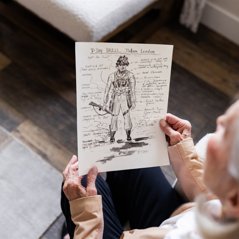 Woman holding a D-Day sketch replica document